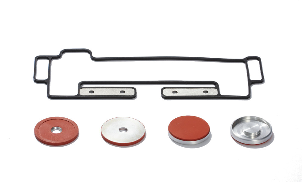 Black and red solid silicone window gaskets and pucks with metal insert molded pieces