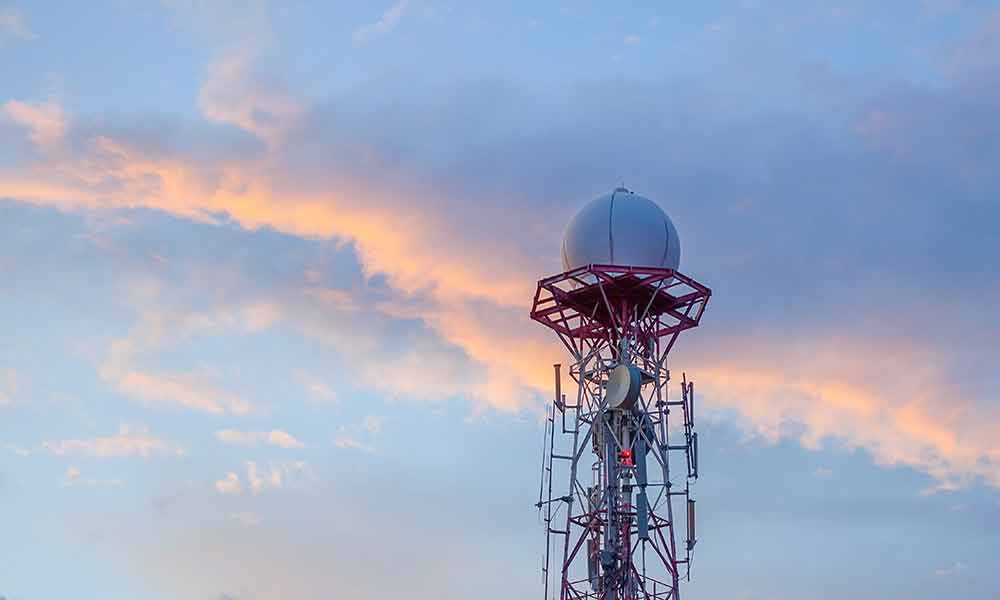 Telecomm tower shown with sunset in the background