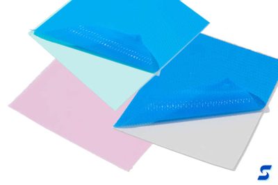Green, pink, and gray square swatches of thermal interface materials 