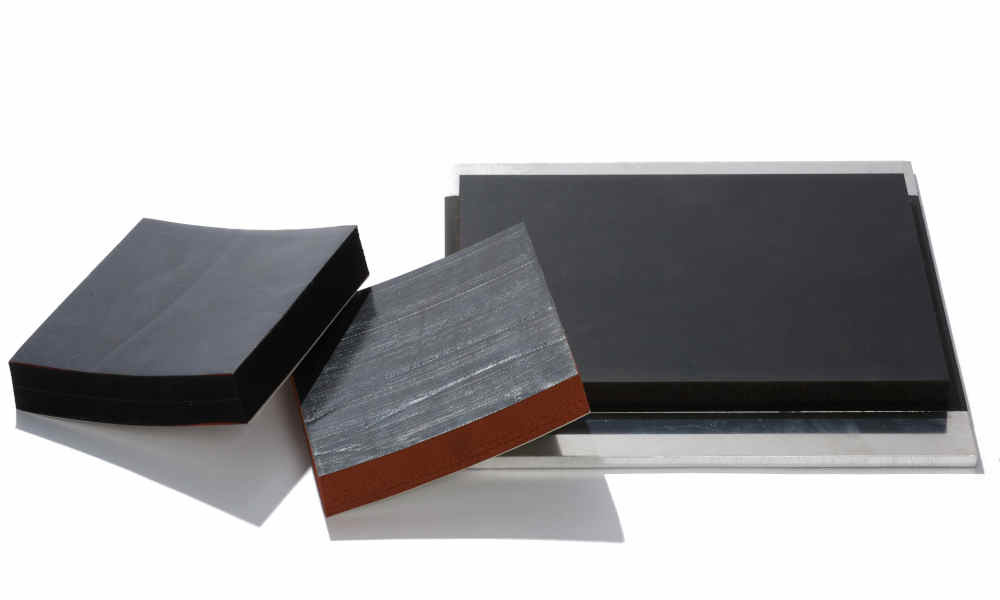 Grounding pads with various surface finishes, one adhered to sheet metal used for ESD protection